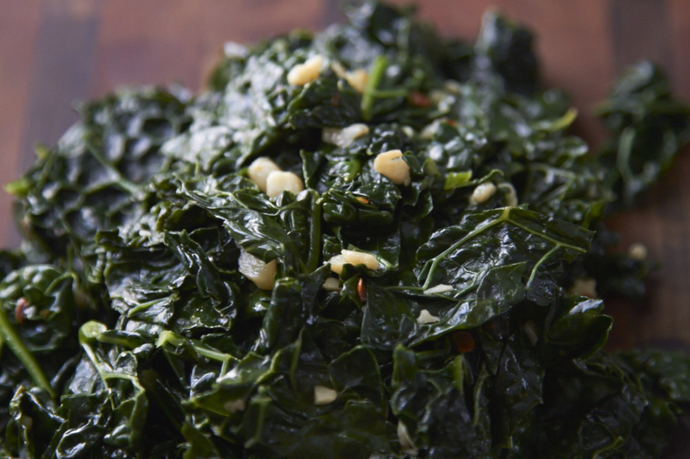 Cooked kale with bits of chopped garlic and crushed red pepper.