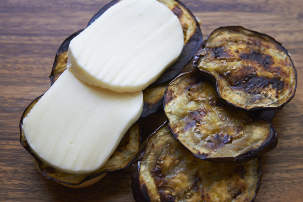 Grilled eggplant and mozzarella cheese placed on two slices of French bread.