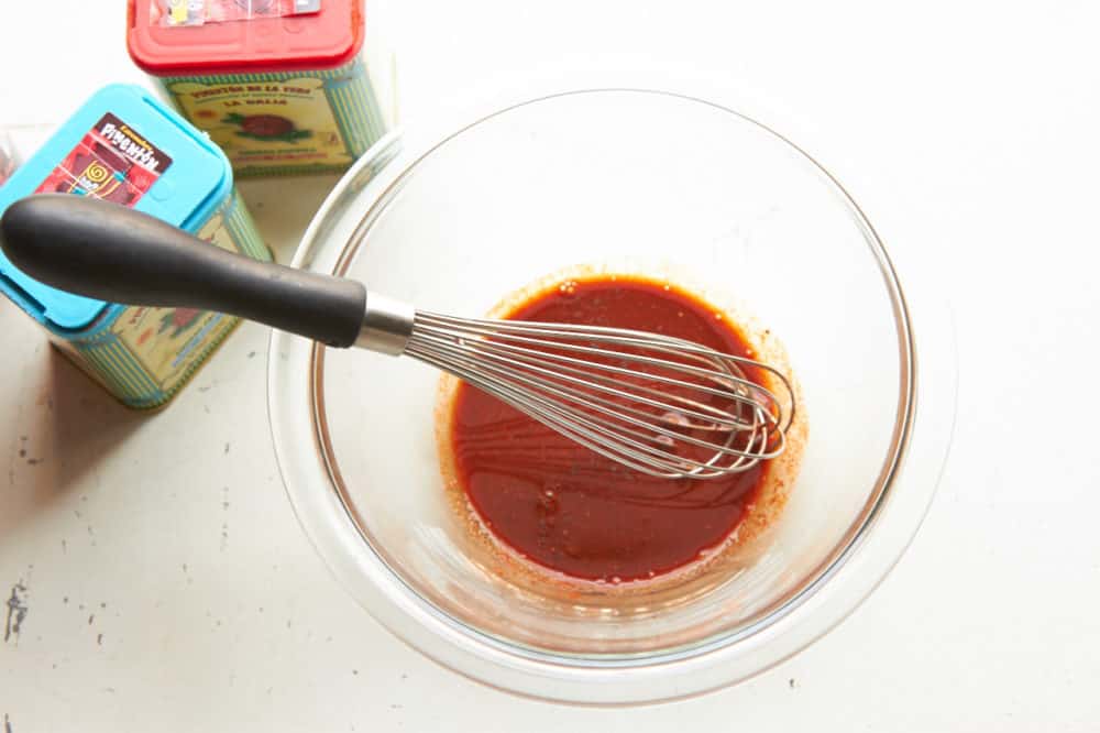 Paprika and red wine vinegar mixed in a glass bowl. 