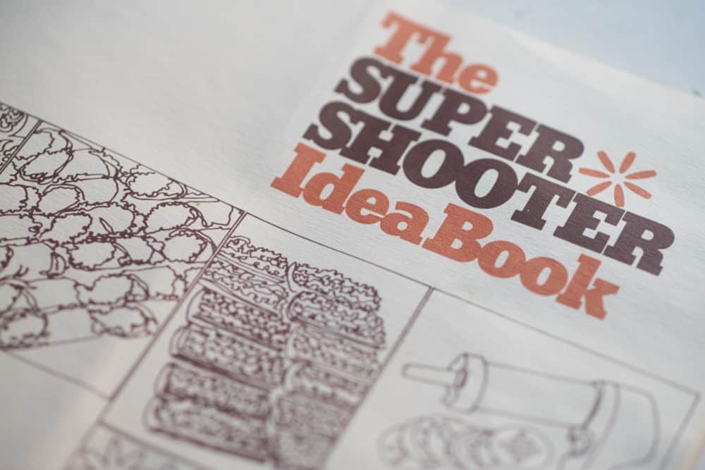 A recipe book entitled, "The Super Shooter Idea Book" featuring simple drawings of the kitchen tool and the food that can be made with it. 