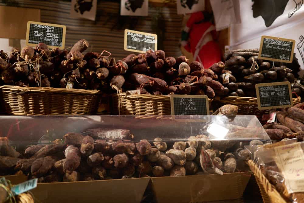 Baskets of local charcuterie for sale at the Christmas market in Reims, France.