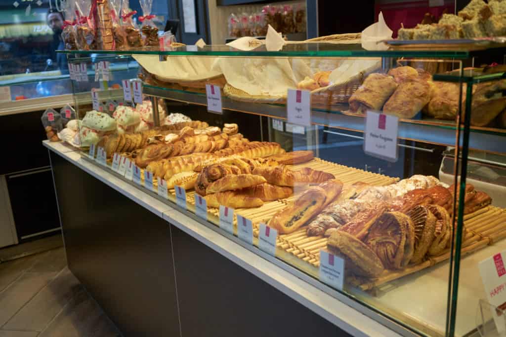 A Viennoiserie case in a Paris bakery. The case holds croissants, palmiers, apple turnovers and other baked goods. 