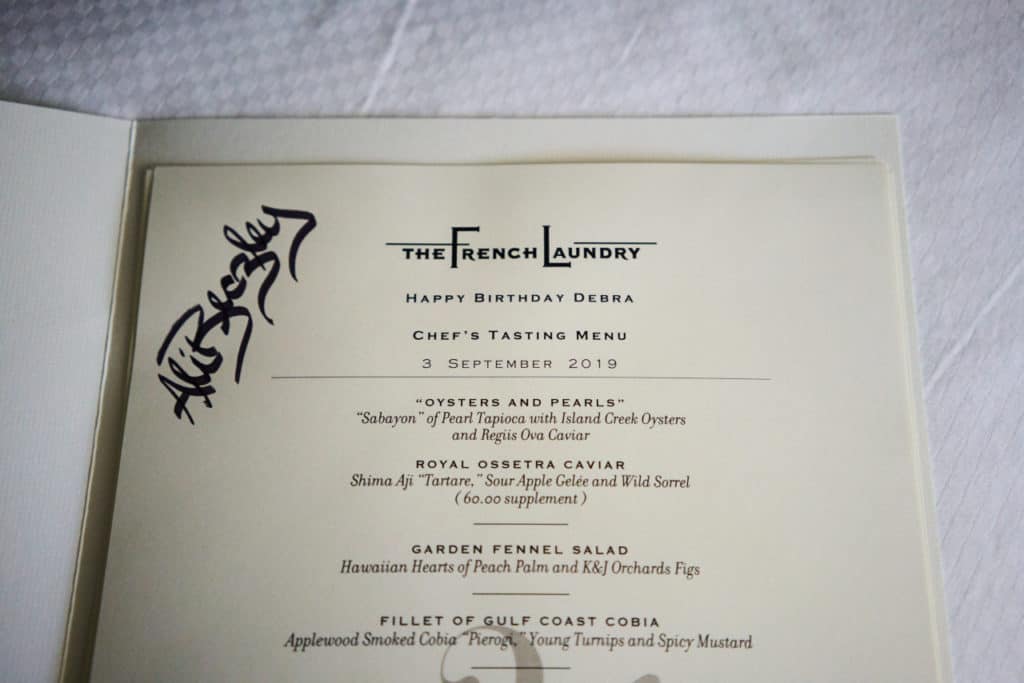 A menu from The French Laundry with a signature on it.