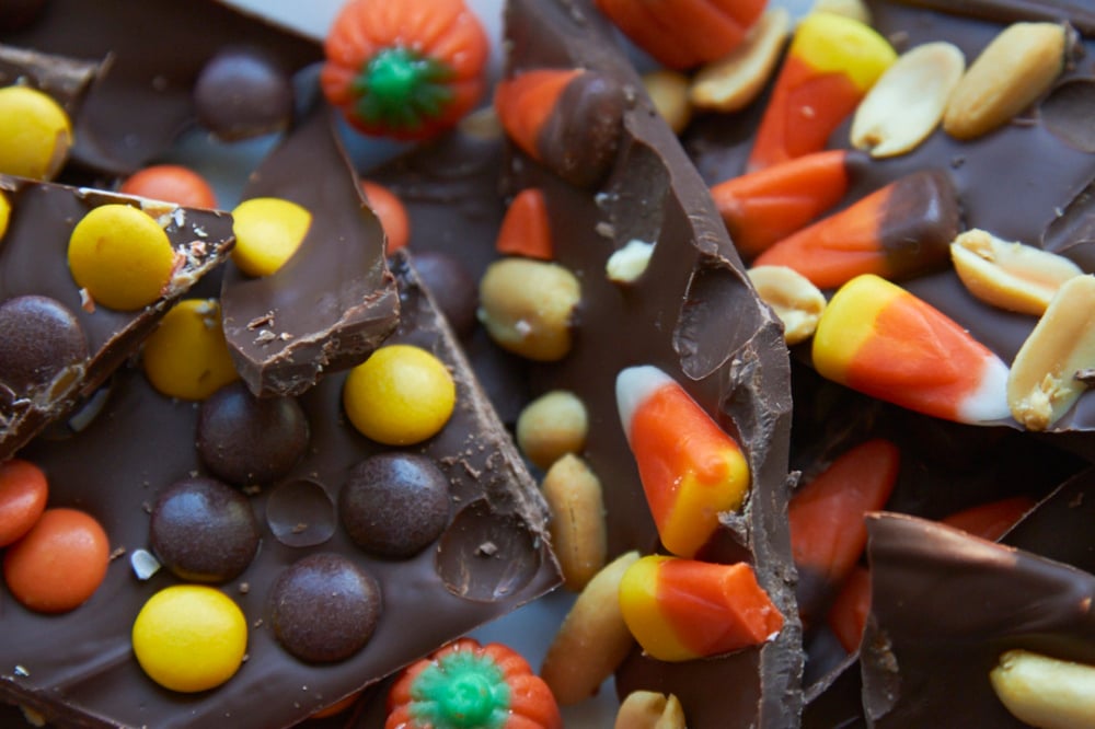 Halloween chocolate bark with candy corn, peanuts, and peanut butter candies. 