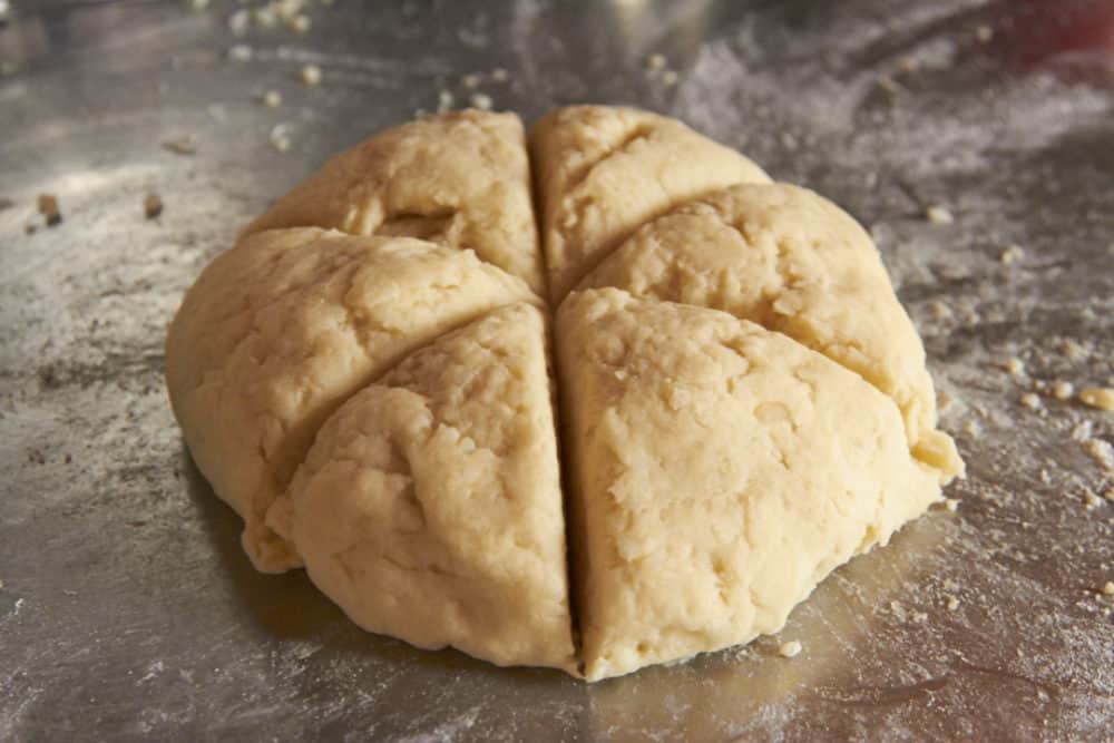 A ball of gnocchi dough sliced into six wedges.