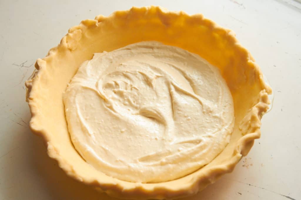 Unbaked pie shell filled with cream cheese filling