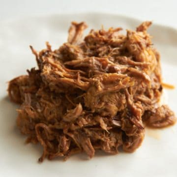 Pulled pork on a white plate.
