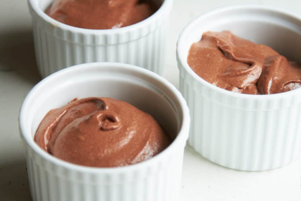 Chocolate mousse in white crocks.
