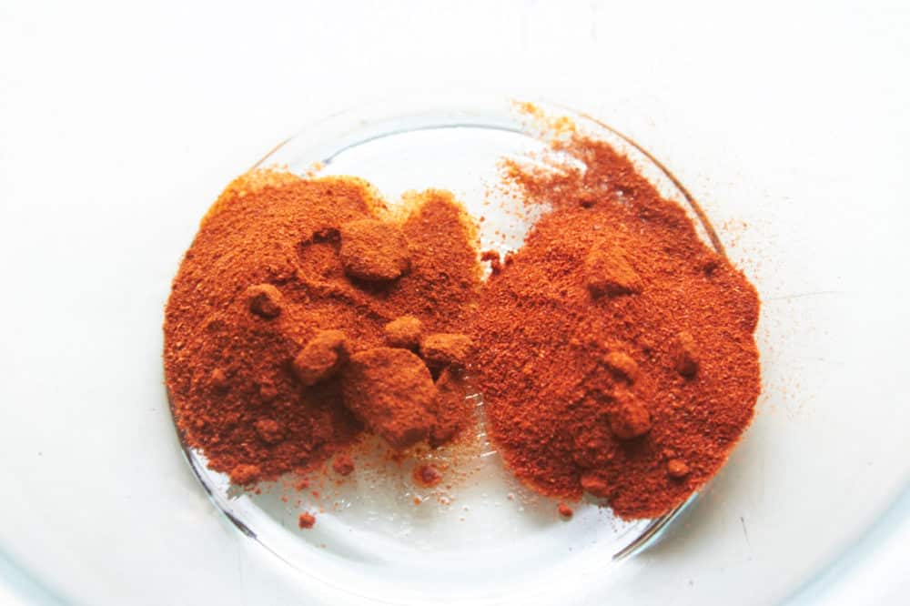 Sweet and hot smoked paprika in a glass bowl.