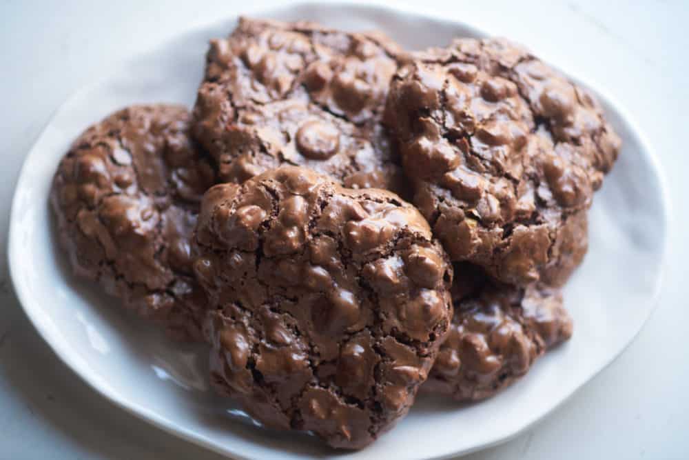 Gluten free chocolate hazelnut cookies on a white plate.