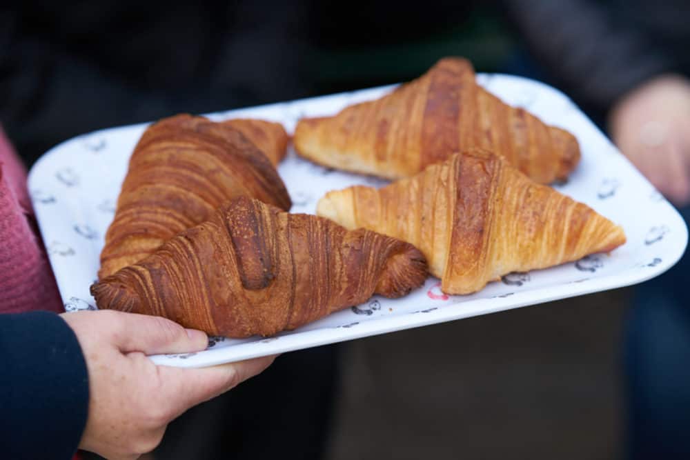 Four croissants on a tray. 