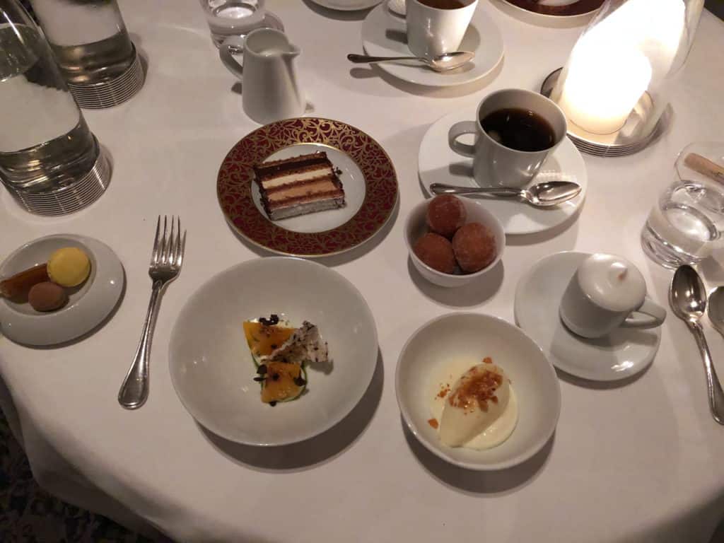 An assortment of desserts on a table with a white tablecloth at The French Laundry.