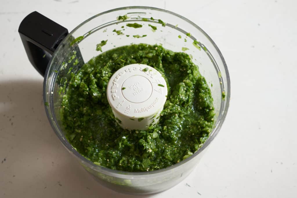 Green shakshuka sauce in a food processor.