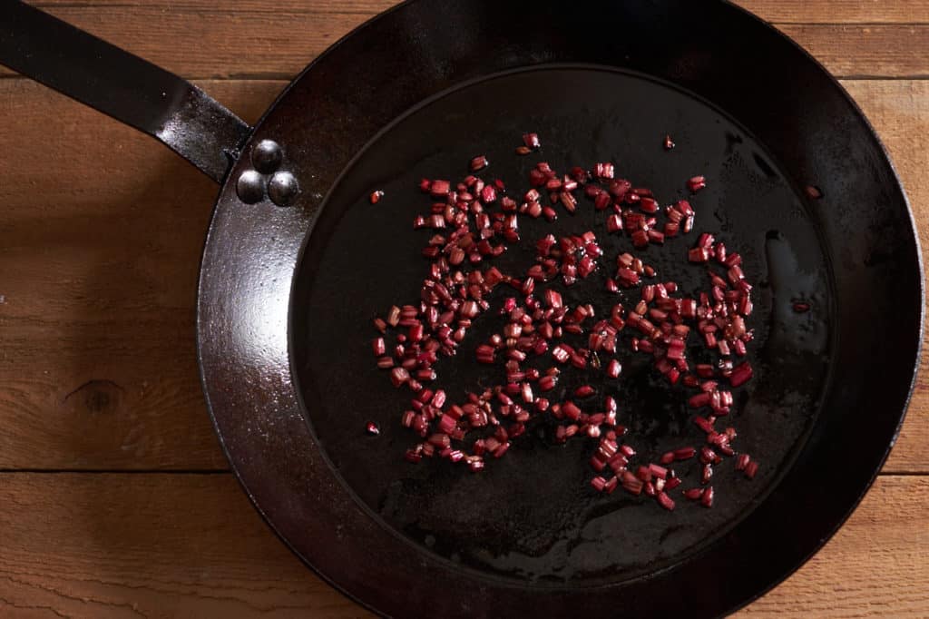 A cast-iron skillet with sauteed beet stems.