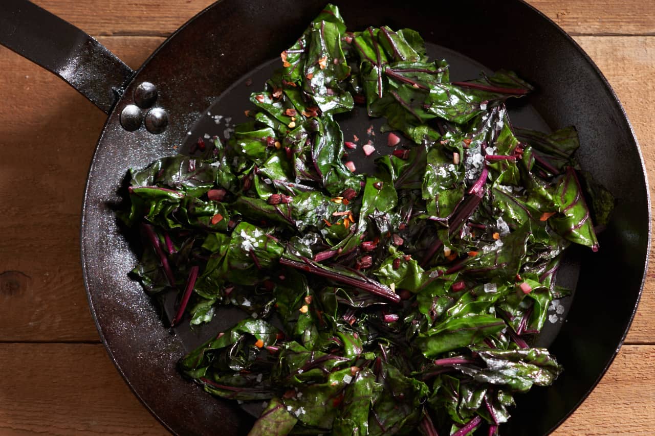 Sautéed beet greens in a cast iron skillet.