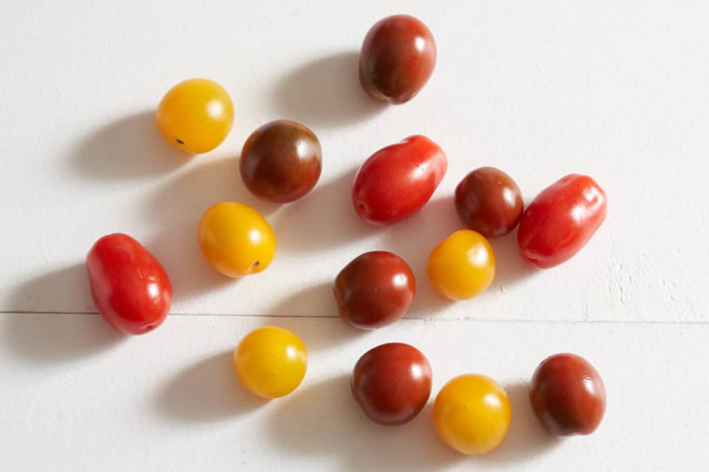 Cherry tomatoes in various shades of red and yellow.