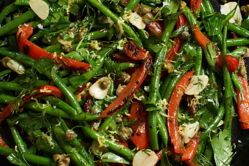 Fresh green bean salad with red peppers, capers and herbs