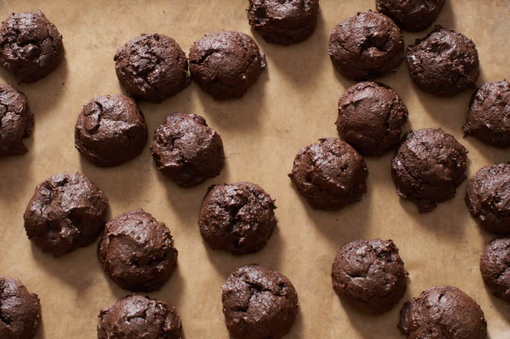 Gluten free triple chocolate cookies on a baking sheet.