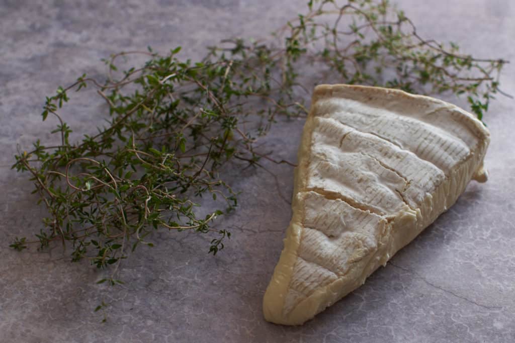 Fresh thyme and a wedge of brie