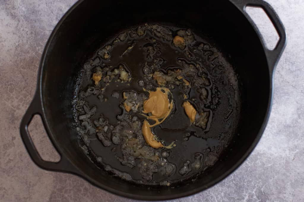 Sautéed shallots with dijon mustard in a cast iron pot.