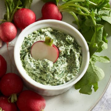 radishes with radish leaf butter on a plate