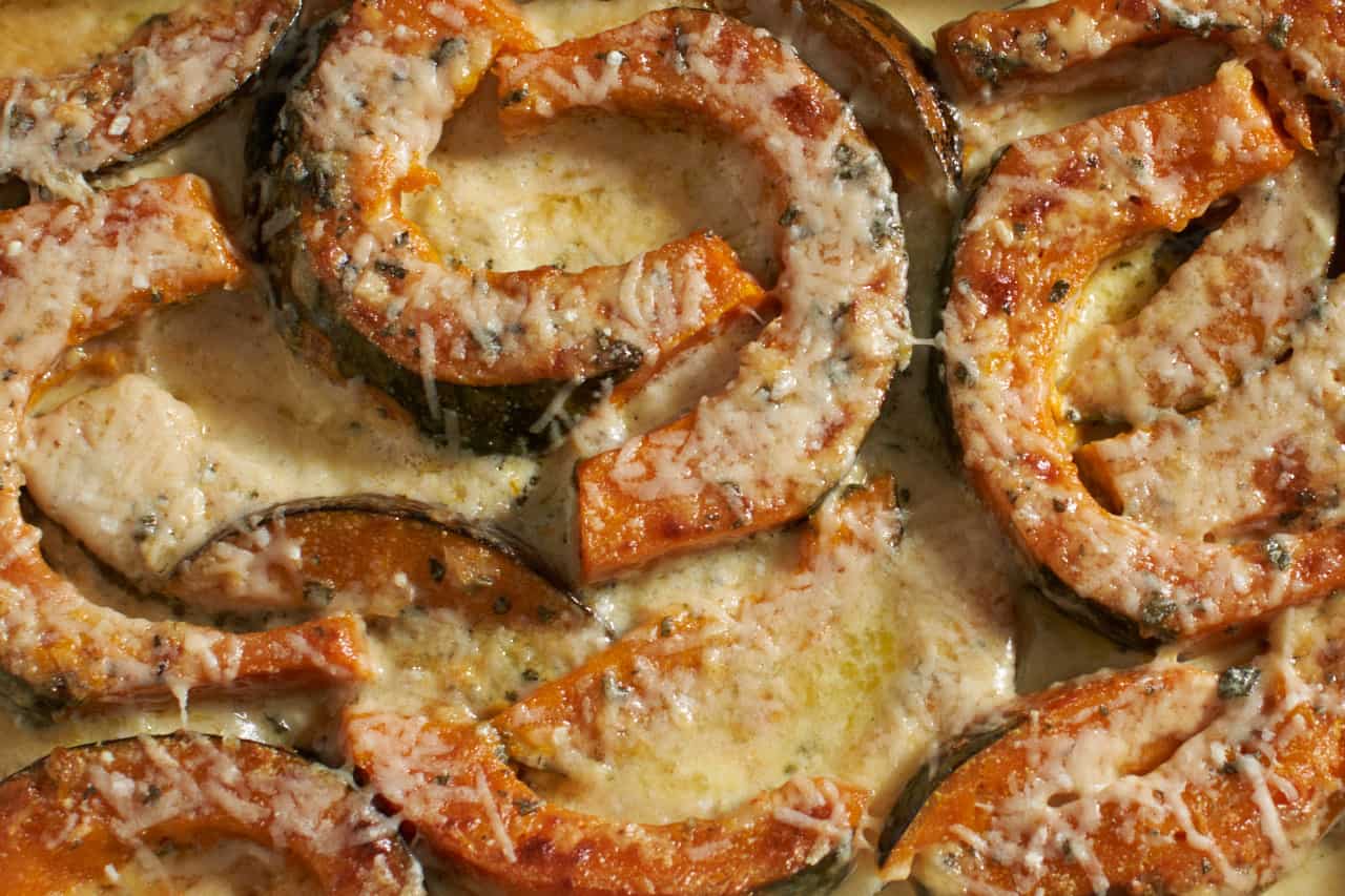 Baked winter squash gratin with melted cheese on top.