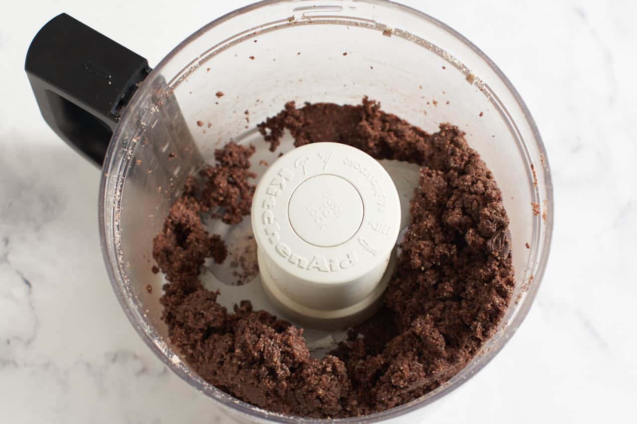 A food processor with finished cookie dough.