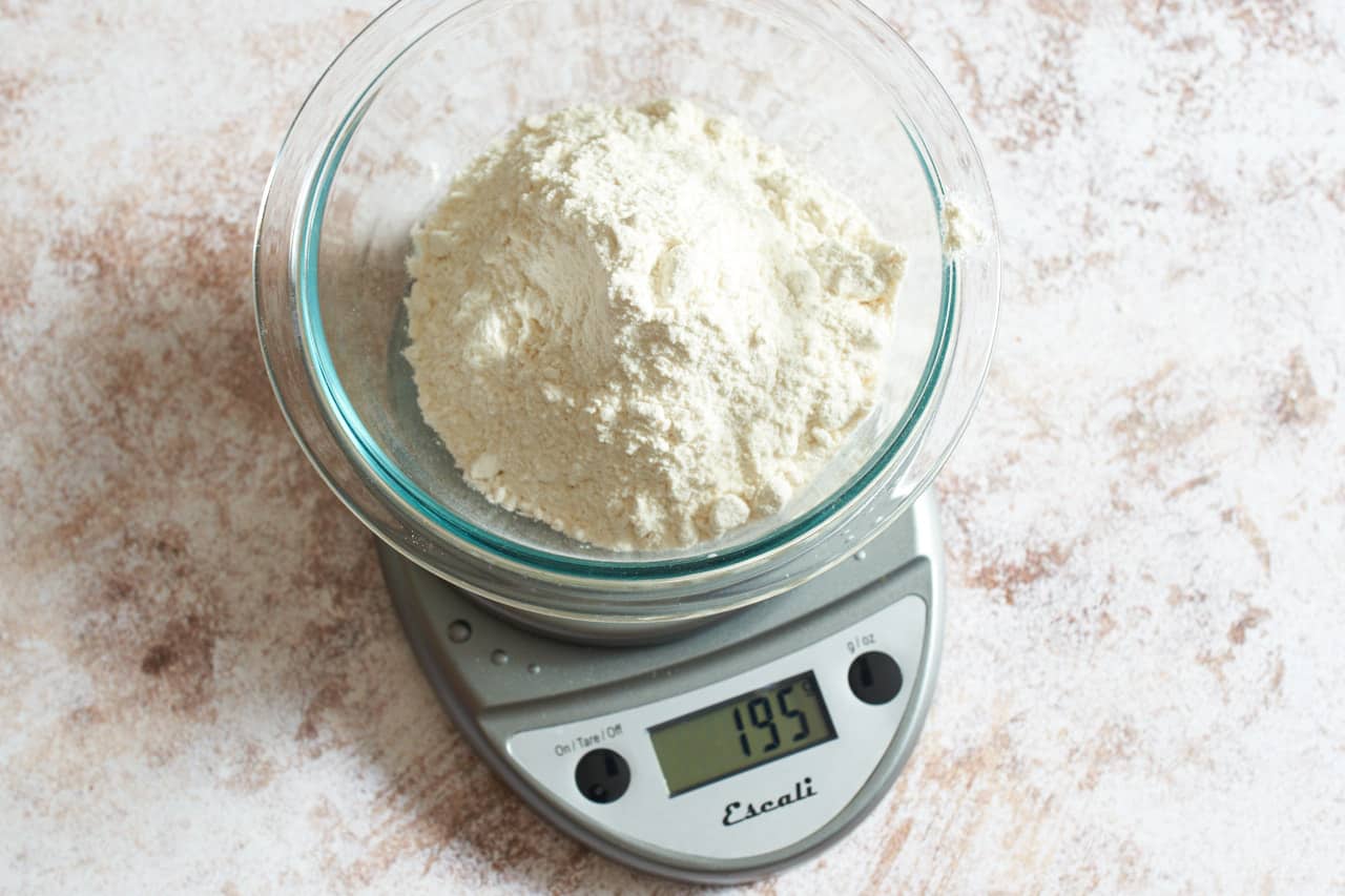 A bowl of flour on a kitchen scale.