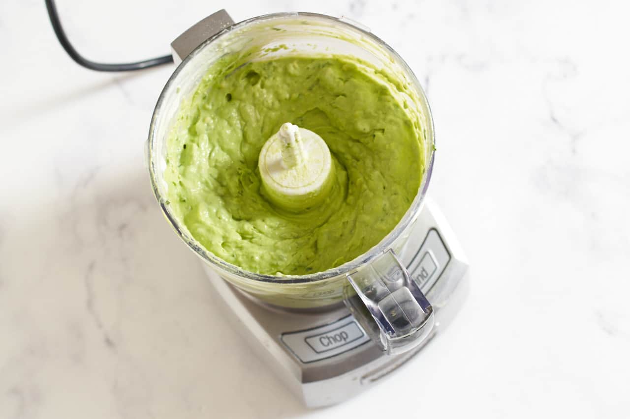 Blended avocado crema in a small food procesor.