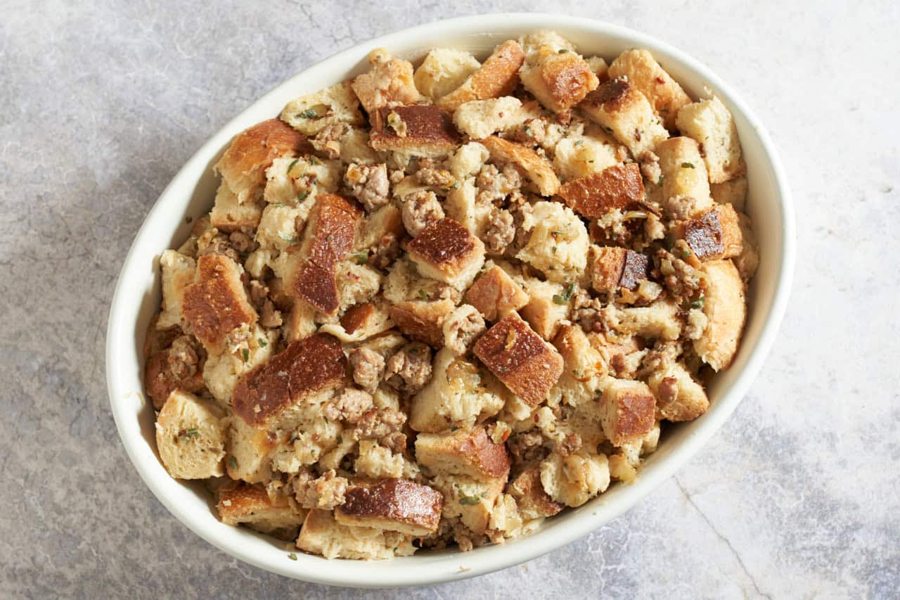 Italian sausage stuffing in a casserole dish ready to be baked.