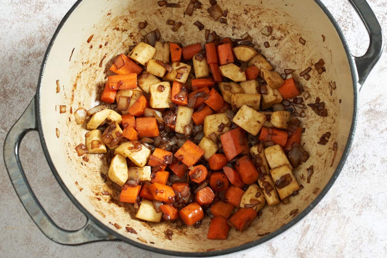 Sautéed onions, parsnips, and carrots in a dutch oven.