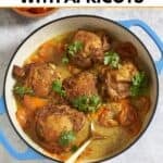 Chicken tagine with apricots garnished with fresh cilantro in a skillet with a gold spoon in it.
