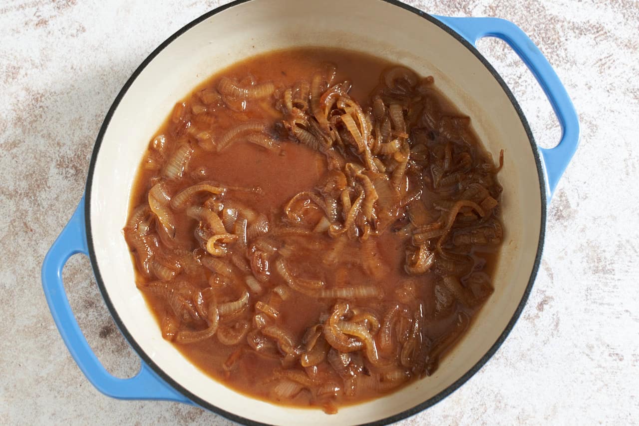 Caramelized onions in a skillet with beer.
